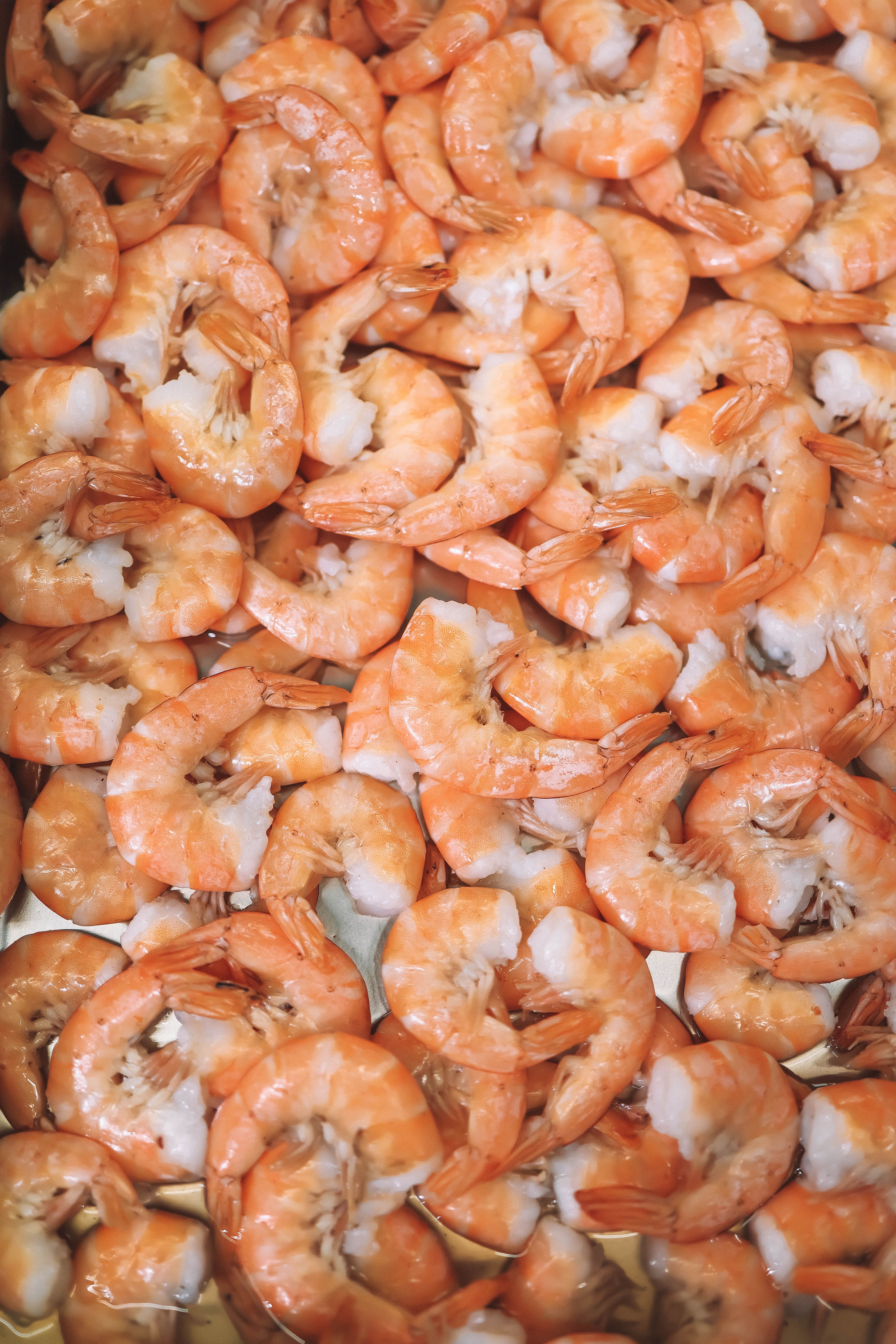 Frozen raw shrimp resting on ice